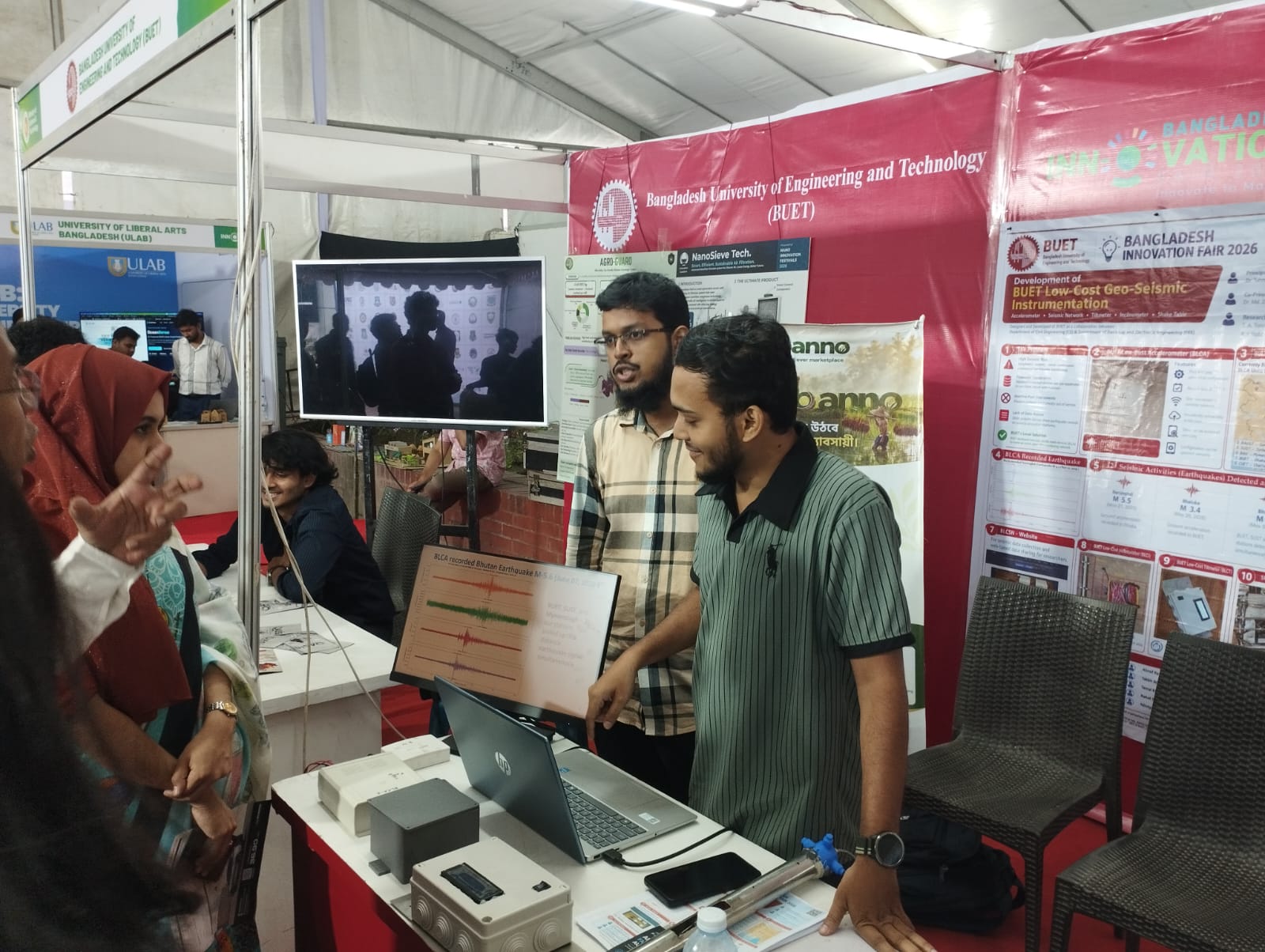 Team member demonstrating live seismic waveforms to visitors